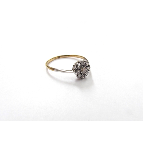 9319 - A diamond daisy ring, shank stamped 18ct. Size M, 1.2g