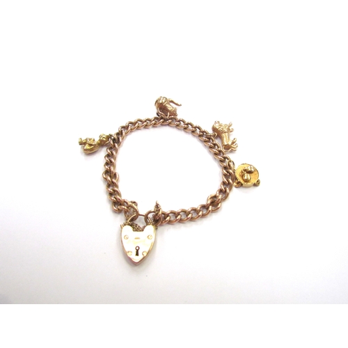 9371 - A 9ct gold charm bracelet hung with various charms including, kettle, Pixie, Bull and Tambourine, 22... 