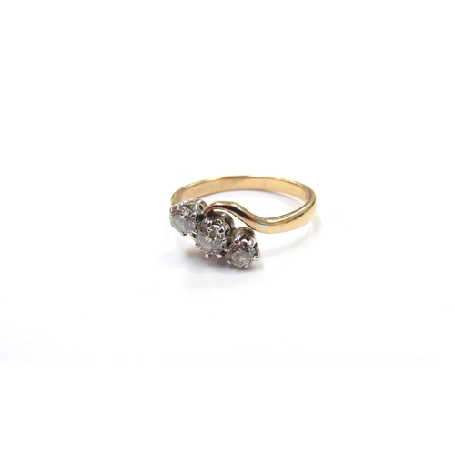 9312 - An 18ct gold three stone diamond crossover ring, 0.45ct total approx. Size N, 2.6g       (R) £200