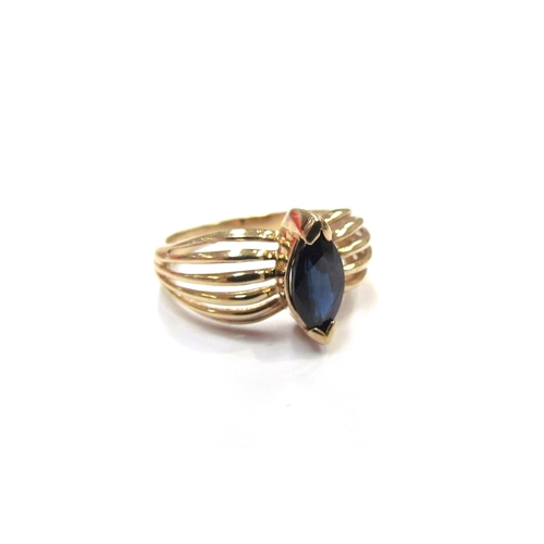 9353 - A 9ct gold ring centrally set with a marquise cut sapphire in an open shoulder. Size P/Q, 3.5g