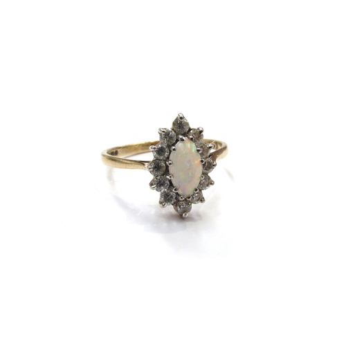 9410 - A 9ct gold opal and white stone cluster ring. Size M, 2g       (E) £50-80