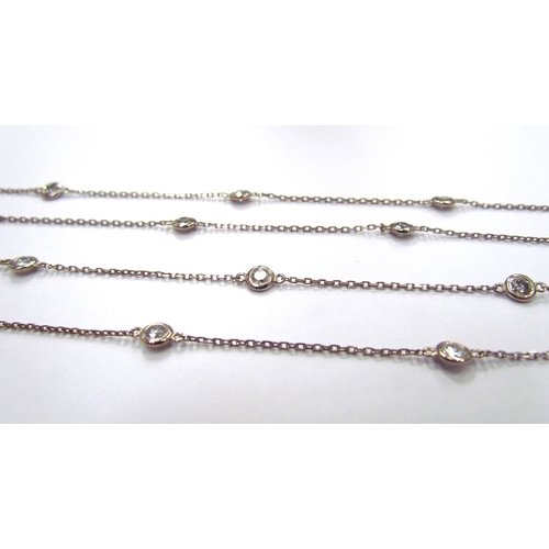 9423 - A white gold diamond set chain, 20 diamonds in rubover settings (3ct total approx) equally spaced on... 