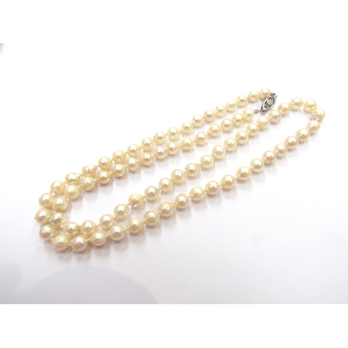 9417 - A cultured freshwater pearl single row necklace, 60cm long, clasp stamped 14k   (C)