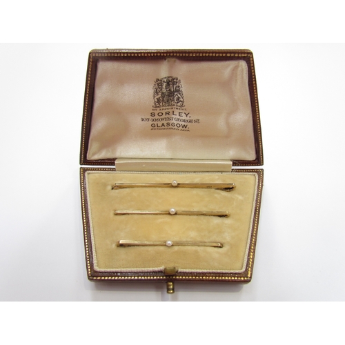 9394 - A set of three graduated stock pins and set with a single pearl, stamped 9ct in fitted case, 4.9g