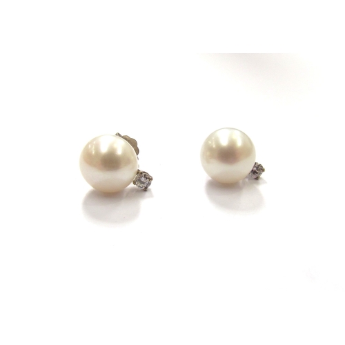 9361 - A pair of single pearl and diamond earrings, stamped 14k to backs, 2.1g         (C)