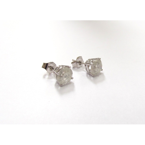 9360 - A pair of white gold diamond stud earrings 1ct each approx, stamped 14k, 1.2g