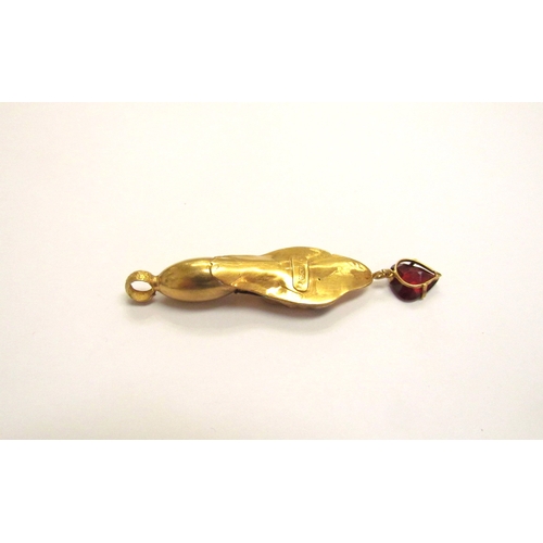 9154 - A gold snake head pendant with garnet set eyes and heart shaped garnet drop, marked c18, 4.1g