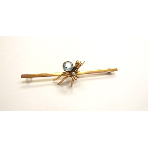 9177 - A gold bar brooch with a spider to centre, having a pearl head and aquamarine body, stamped 9ct, 7.8... 