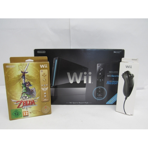 7003 - A boxed Nintendo Wii Sports Resort Pack computer game console in black, together with a boxed The Le... 