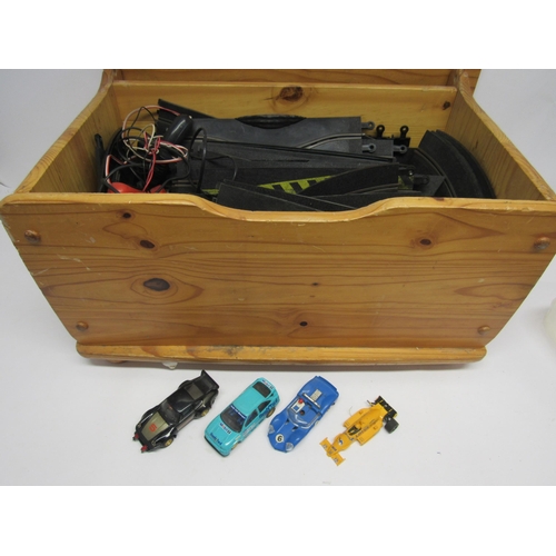 7206 - A wooden chest containing four heavily playworn Scalextric slot racing cars, two hand throttles and ... 