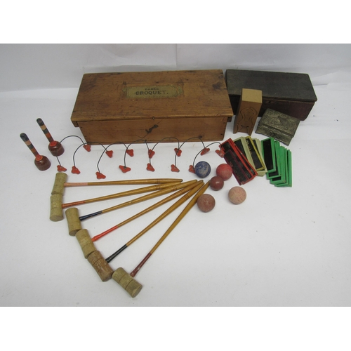 7130 - An early 20th Century tabletop croquet set in original pine box with applied paper labels, comprisin... 