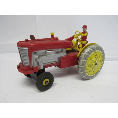 7171 - A Louis Marx battery operated red plastic tractor with litho printed tinplate wheels, 24cm long