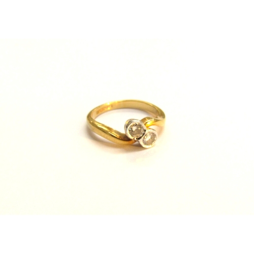 9065 - An 18ct gold diamond crossover ring. Size I/J, 3.2g