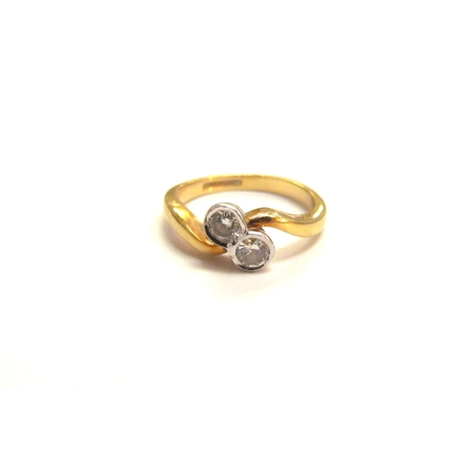 9065 - An 18ct gold diamond crossover ring. Size I/J, 3.2g