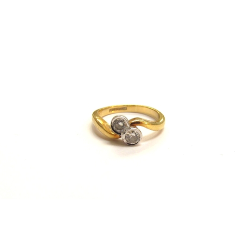 9065 - An 18ct gold diamond crossover ring. Size I/J, 3.2g