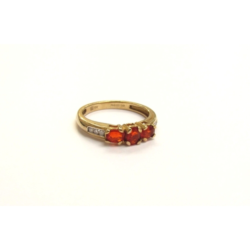 9121 - A 9ct gold fire opal and diamond ring. Size J, 1.7g