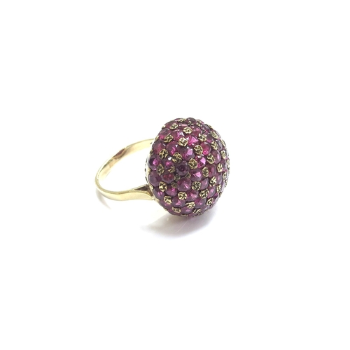 9290 - A gold ring with a domed cluster of rubies, stamped 9ct. Size O, 7.8g   (R) £100