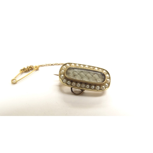 9317 - A Victorian gold woven hair panel brooch, the central glass panel framed by pearls, unmarked, 4g    ... 