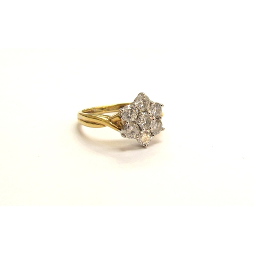 9146 - An 18ct gold diamond daisy ring, 10mm diameter. Size M/N, 4.2g