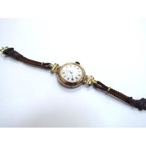 9134 - A 9ct gold cased wristwatch with white enamel dial, on leather strap   (E) £40-60