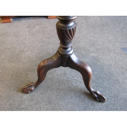 1004 - A stained mahogany occasional table with piecrust top, wrythen column, tripod legs on ball and claw ... 