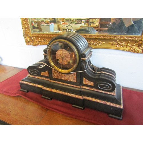 1017 - A slate and marble mantel clock with key and pendulum