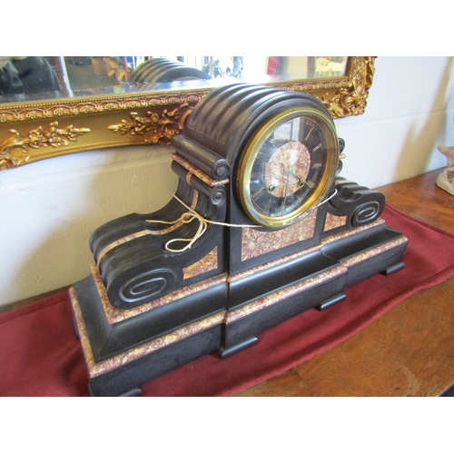 1017 - A slate and marble mantel clock with key and pendulum