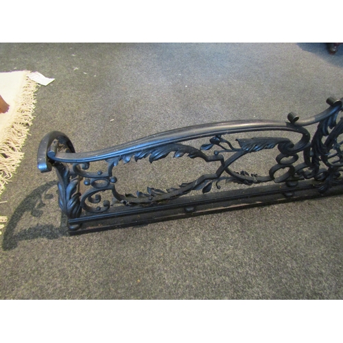 1050 - A cast iron fire fender with central lattice and rosette decoration 131cm x 20cm x 35.5cm