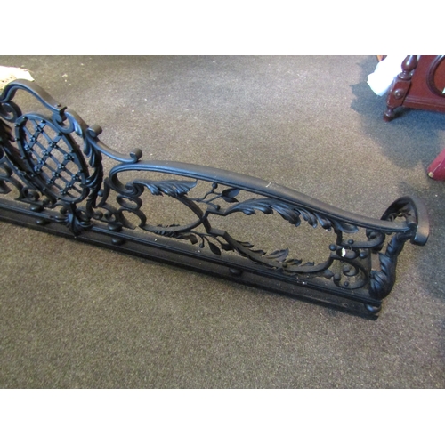 1050 - A cast iron fire fender with central lattice and rosette decoration 131cm x 20cm x 35.5cm