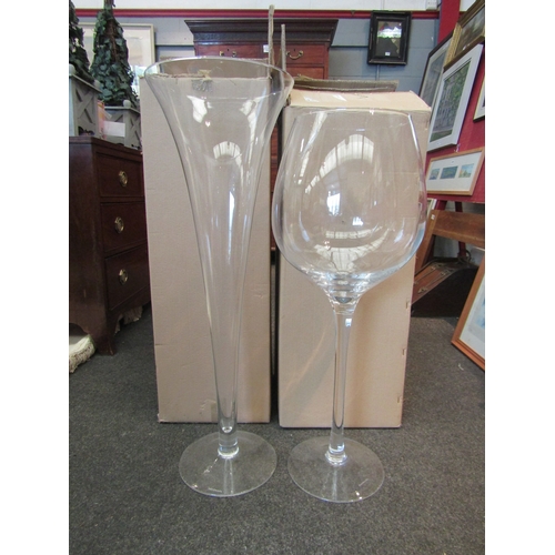 1070 - Two LSA international large scale floor standing glasses, wine glass and champagne flute, with boxes... 