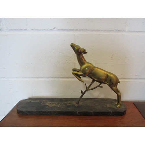 1077 - A brass leaping deer figure on marble base, 30cm tall