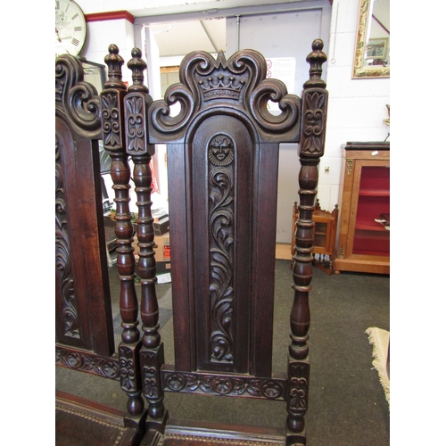 1098 - A pair of 17th Century style carved oak hall chairs with coronet crest, painted seal and stud border... 