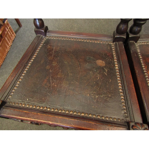 1098 - A pair of 17th Century style carved oak hall chairs with coronet crest, painted seal and stud border... 