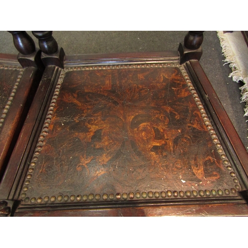 1098 - A pair of 17th Century style carved oak hall chairs with coronet crest, painted seal and stud border... 