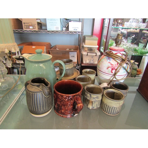 1393 - A Studio pottery set of six cups and saucers with ribbed design, a Denby coffee jug, pottery lamp ba... 