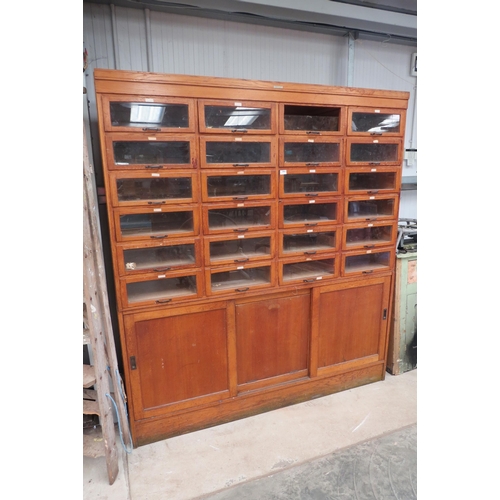 2063 - A haberdashery shop display unit of 24 glass drawers, one a/f