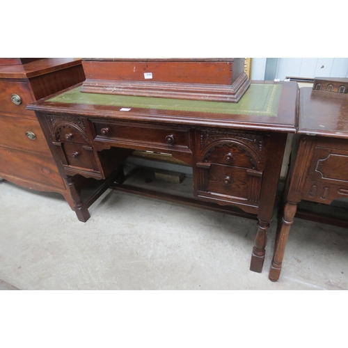 2106 - A 1950's oak old charm style desk with a leather top   (R) £30