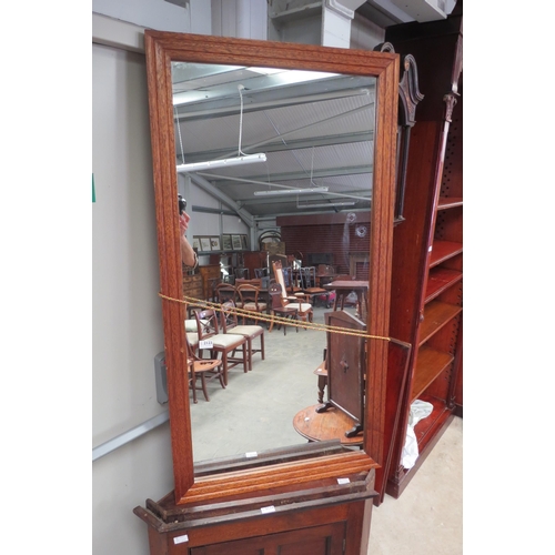 2123 - A large oak framed mirror