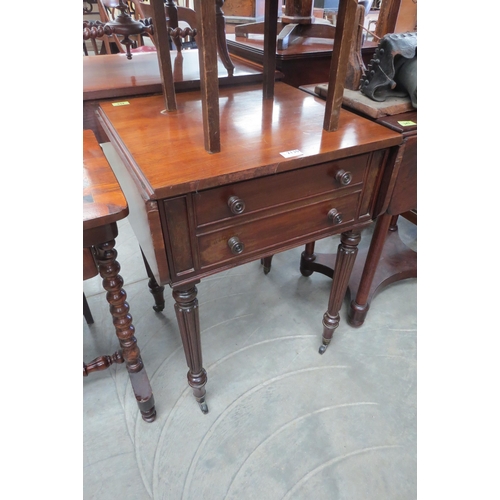 2130 - A mahogany reeded leg drop leaf work table with two drawers, on castors