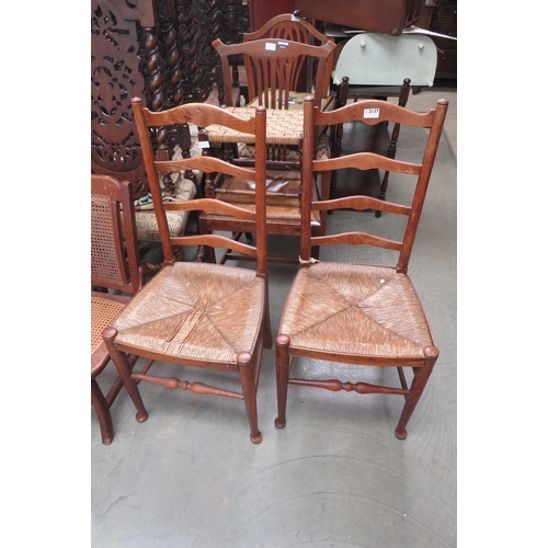 2137 - A pair of oak ladder back rush seated chairs   (E) £10-15