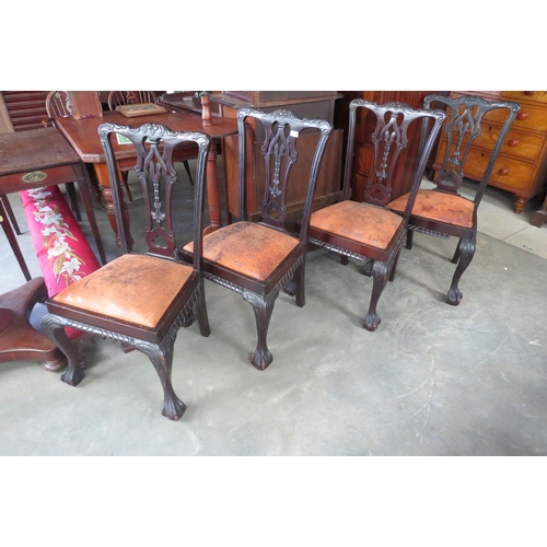 2148 - A set of four mahogany carved dining chairs on ball and claw feet