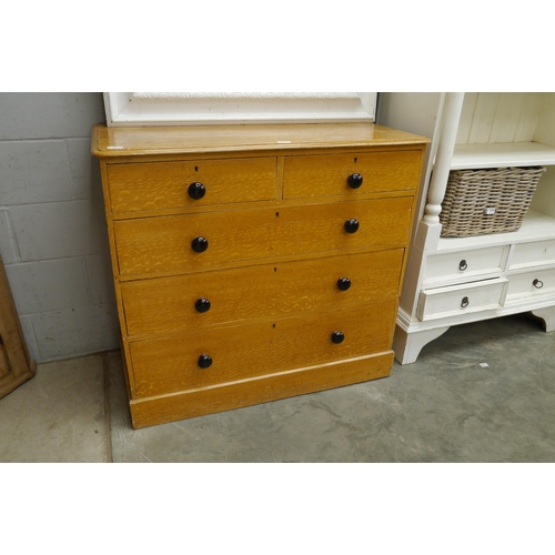 2229 - An early 20th Century figured oak chest of two short over three long drawers, plinth base, ebonised ... 