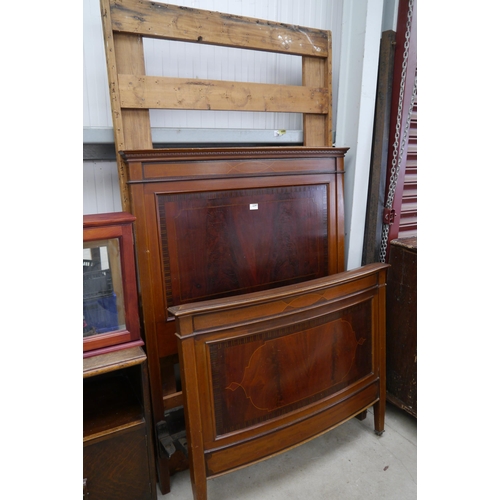 2297 - An Edwardian mahogany inlay single bed frame on castors