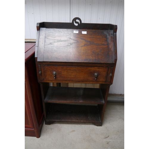 2309 - An early 20th Century oak hall bureau, the fall front over shelf space   (E) £10-15