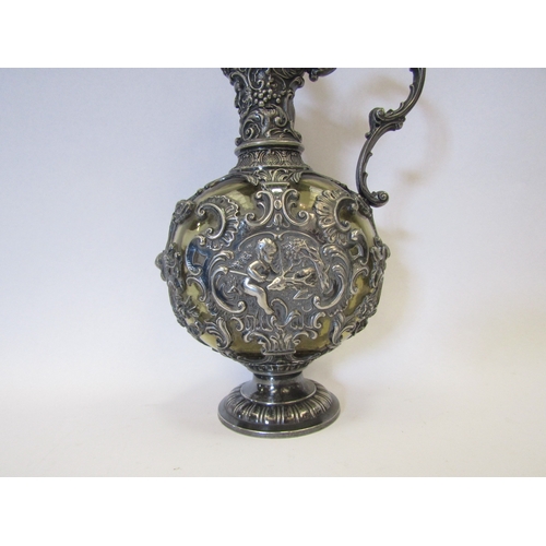 1282 - A 19th Century Bacchus style carafe with ornate plated mask and cherub design, green glass body with... 