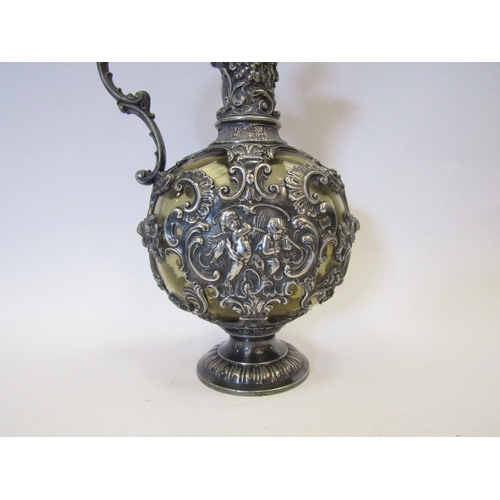 1282 - A 19th Century Bacchus style carafe with ornate plated mask and cherub design, green glass body with... 