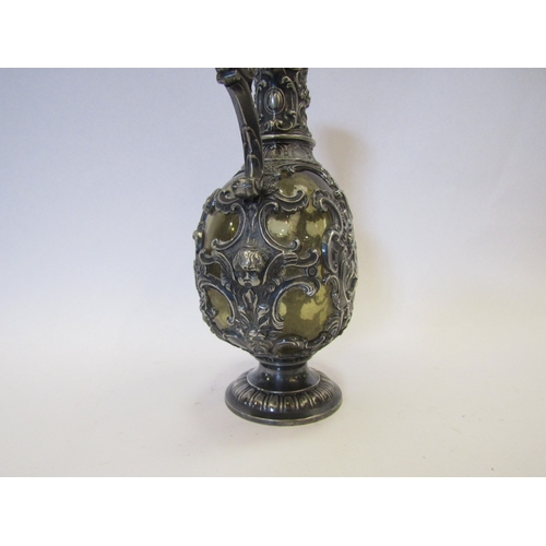 1282 - A 19th Century Bacchus style carafe with ornate plated mask and cherub design, green glass body with... 