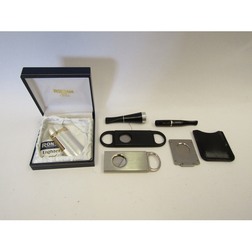 1319 - Three cigar cutters, a cigar and cigarette holder along with a Ronson lighter (6)