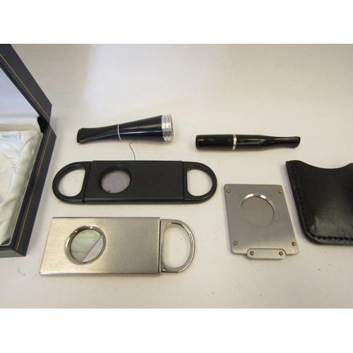 1319 - Three cigar cutters, a cigar and cigarette holder along with a Ronson lighter (6)