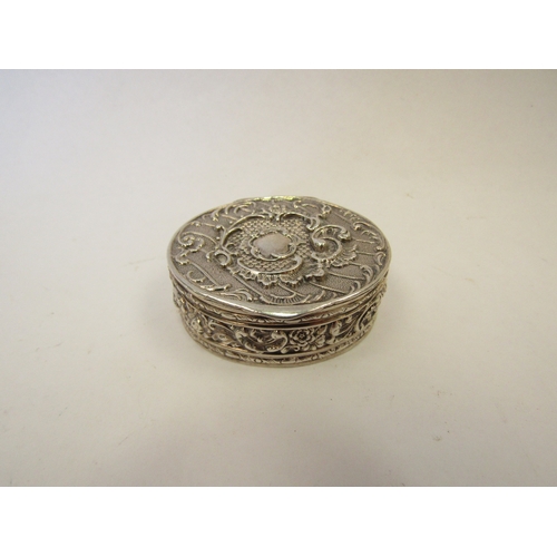 1323 - A Continental silver oval pot with embossed floral decoration.  Import marks London 1894